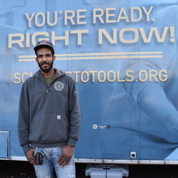 Jay McMann standing in front of the School Tools trailer.