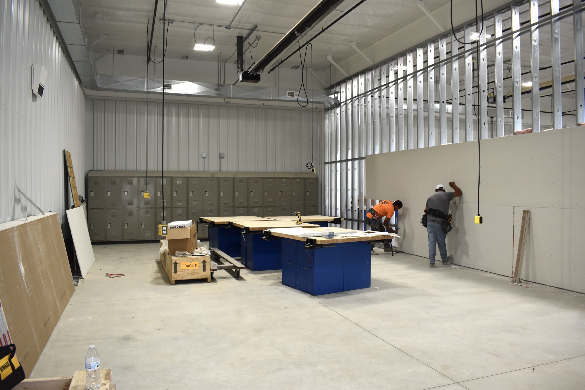 a large garage like space with lockers and work tables