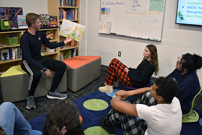 A Teacher Academy student practices reading to a group